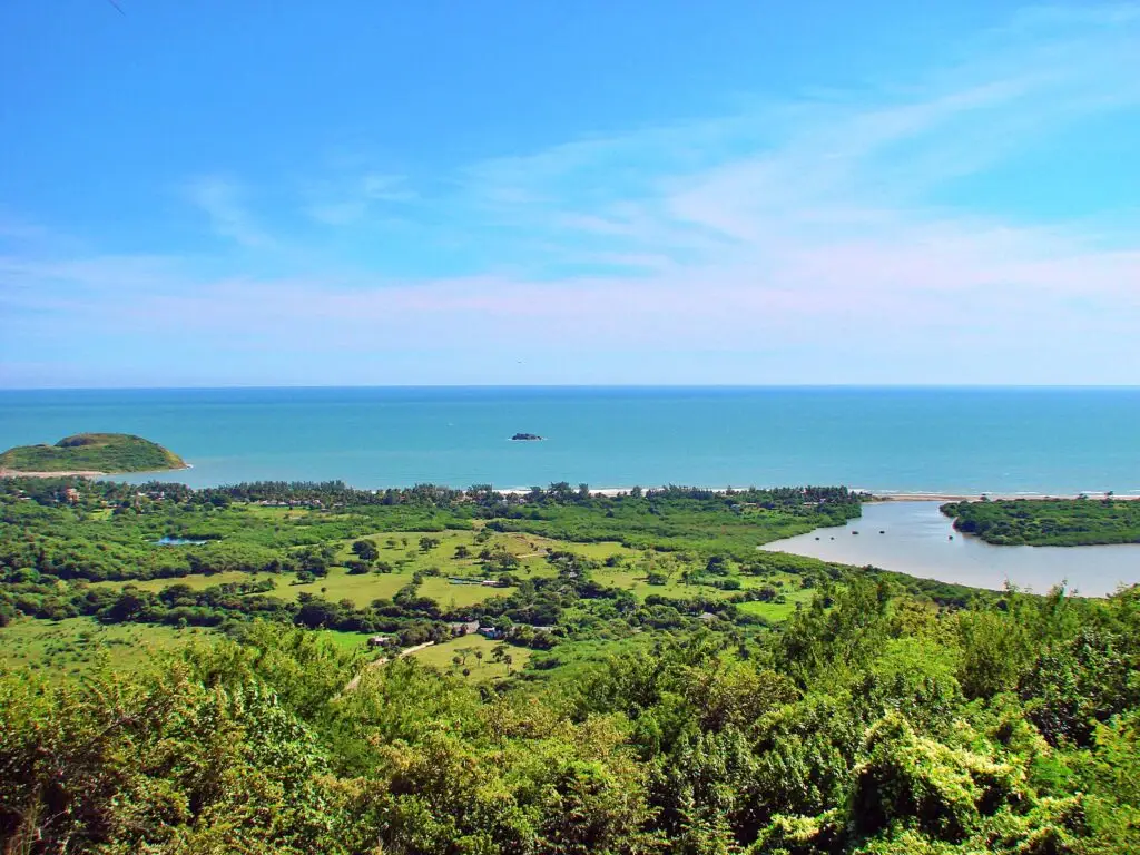 Vista panorámica desde Quiahuiztlán hacia el Golfo de México, con manglares, costa y mar azul al fondo.